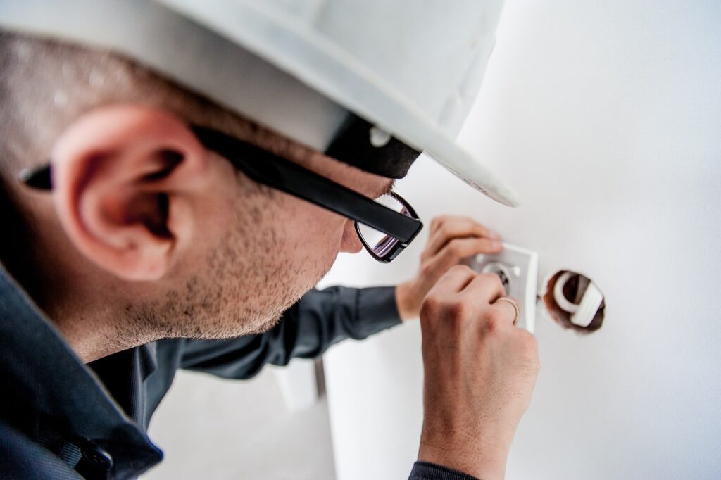 Electrican working on wall plate